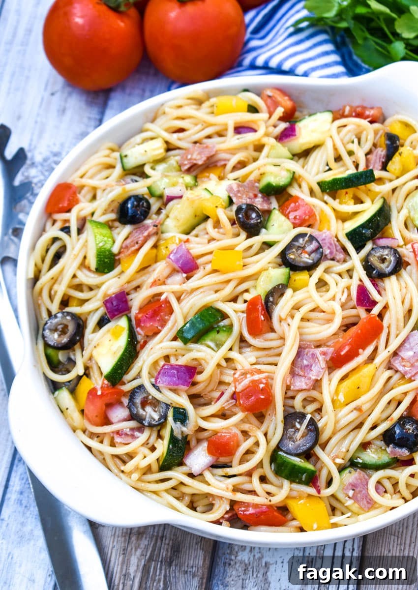cold spaghetti salad in a white serving bowl