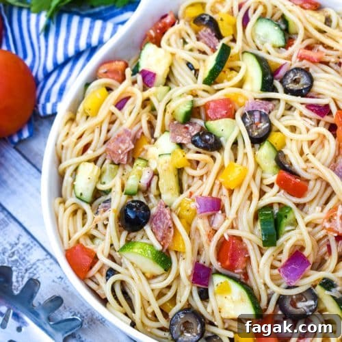 cold spaghetti salad in a white serving bowl