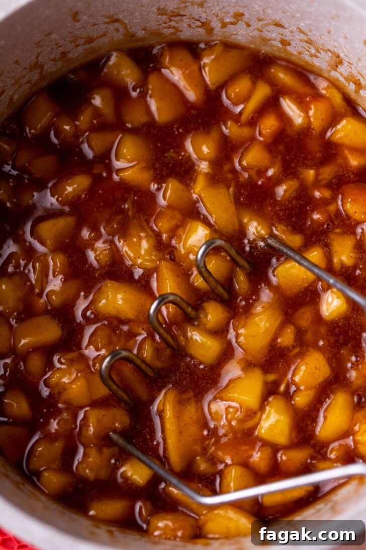 Homemade Peach Pie Filling Recipe for Canning and Baking 6 Peach filling with a masher.