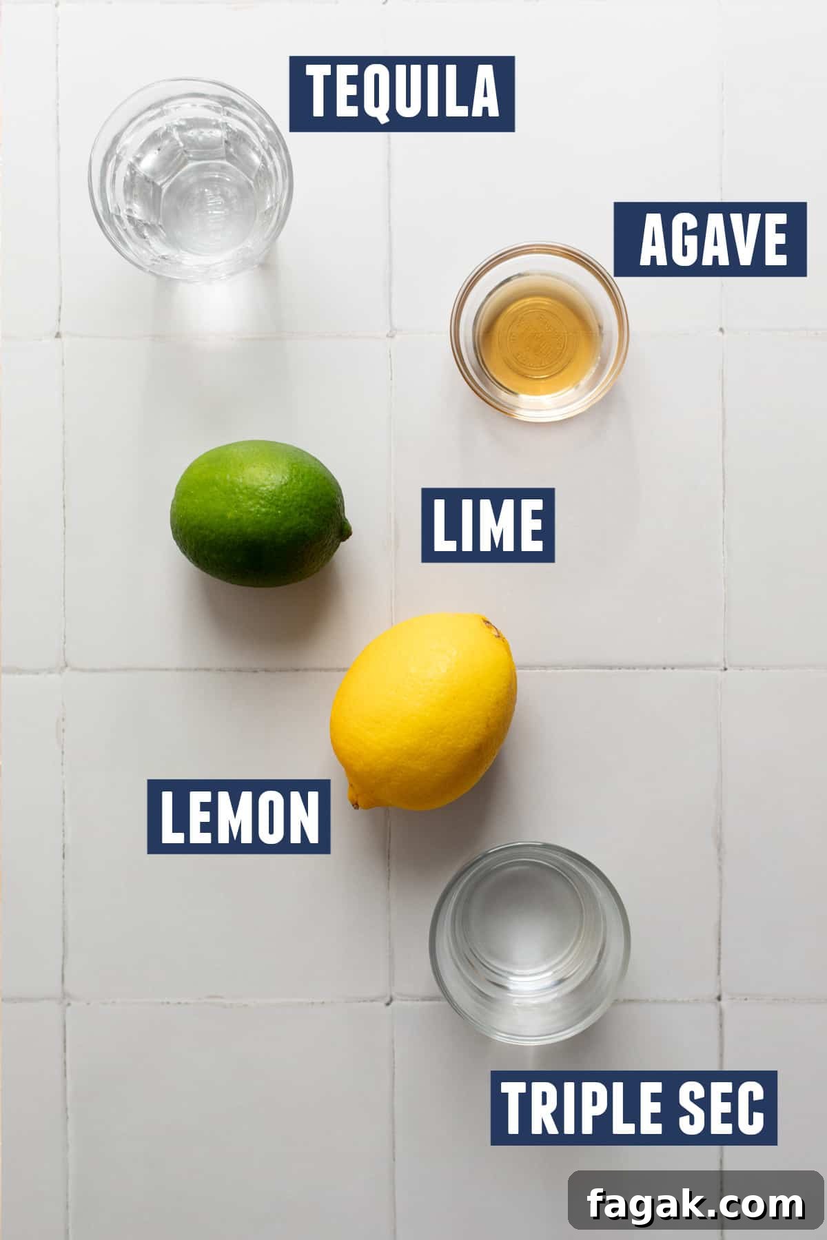 Ingredients needed to make a lemon margarita laid out on the counter. 