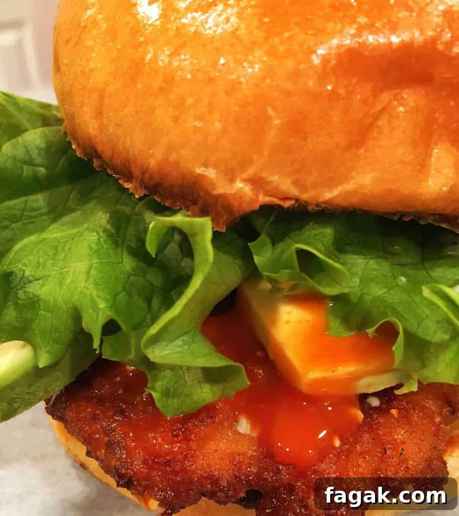 Buffalo Chicken Sandwich with Bleu Cheese and Crispy Ranch 2 A sandwich made of breaded chicken, blue cheese, avocado, lettuce and a buffalo sauce