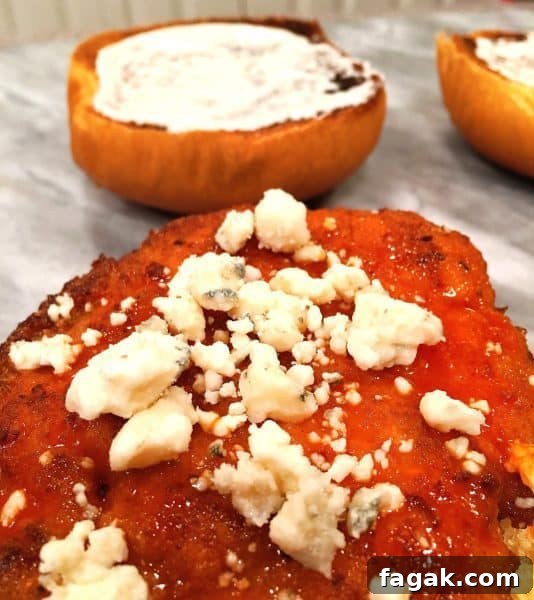 Buffalo Chicken Sandwich with Bleu Cheese and Crispy Ranch 6 blue cheese sprinkled on top of buffalo chicken patty