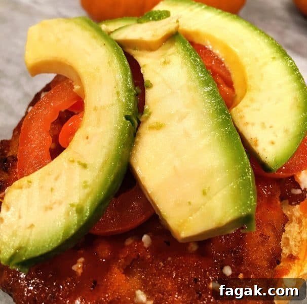 Buffalo Chicken Sandwich with Bleu Cheese and Crispy Ranch 7 sliced avocado and tomato on top of chicken