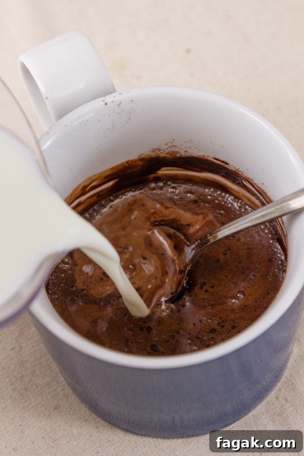 How to make Single Serving Hot Cocoa: Stir in the remainder of the milk until the mug is full. 