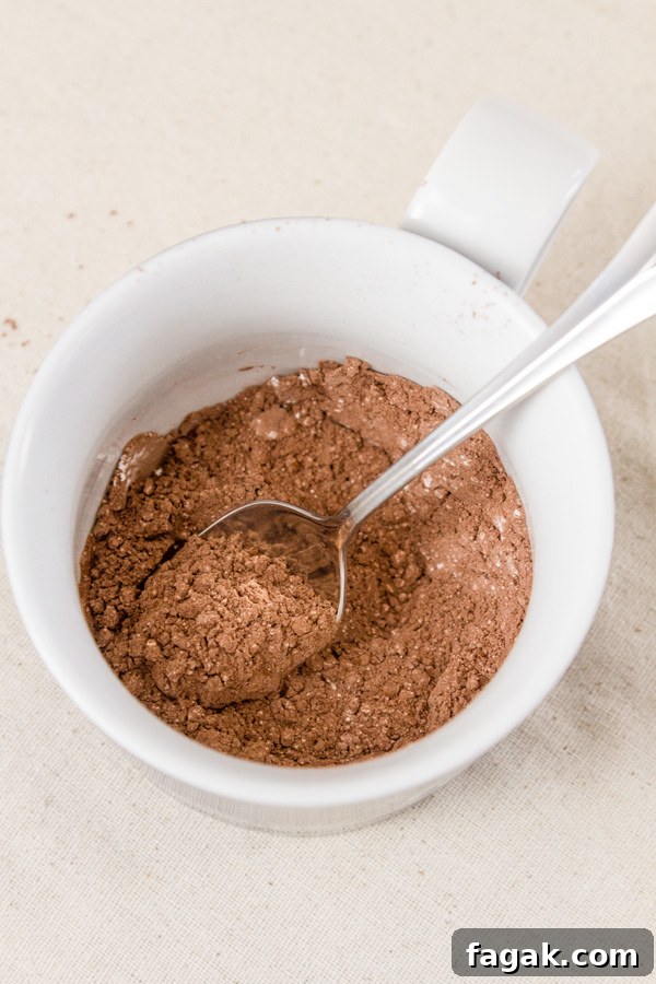 How to make Single Serving Hot Cocoa: Place the cocoa and the powdered sugar in the bottom of the mug, and mix together thoroughly. 