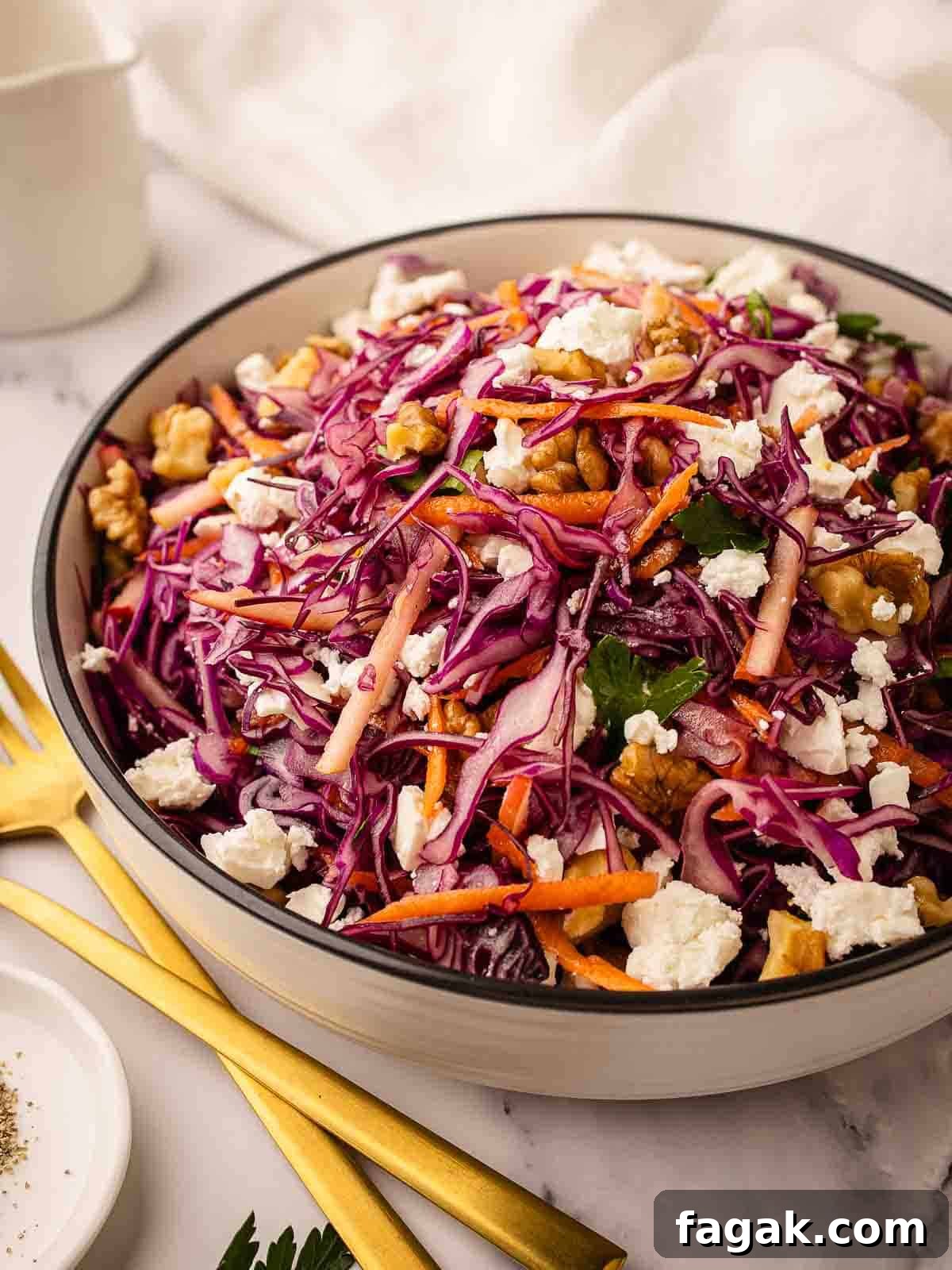 Red Cabbage Salad with red cabbage, grated carrot topped with feta in a round serving bowl.