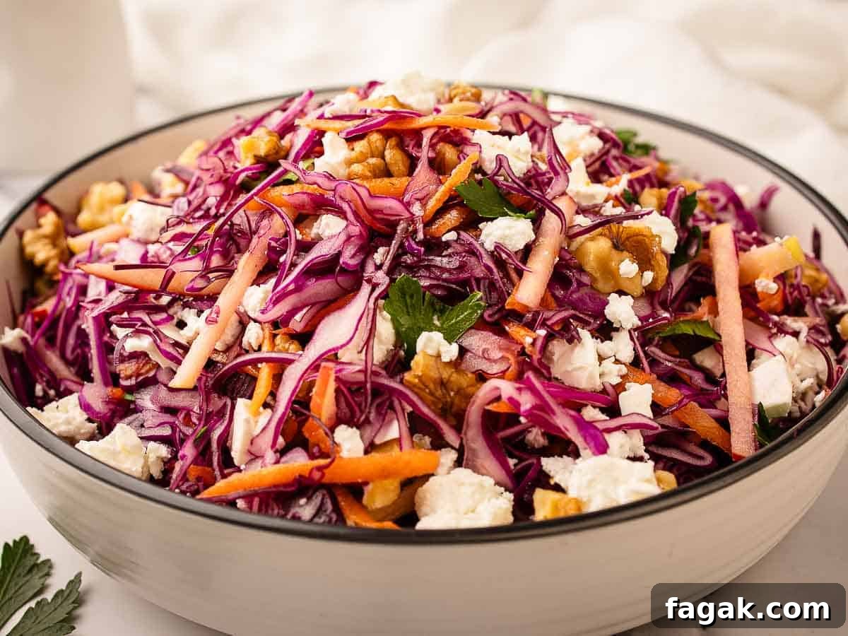 Close up of a salad of red cabbage, carrots and apple.