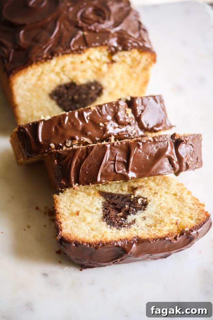 A buttery, mini loaf cake with vanilla cake on the outside and a surprise chocolate heart on the inside!