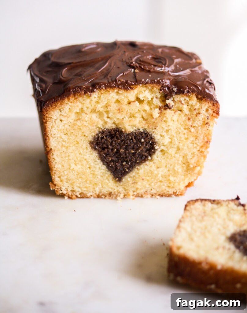 A buttery, mini loaf cake with vanilla cake on the outside and a surprise chocolate heart on the inside!