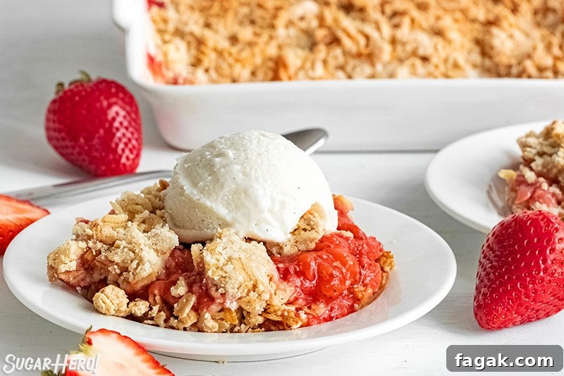 Scoop of Strawberry Crisp with vanilla ice cream on top.