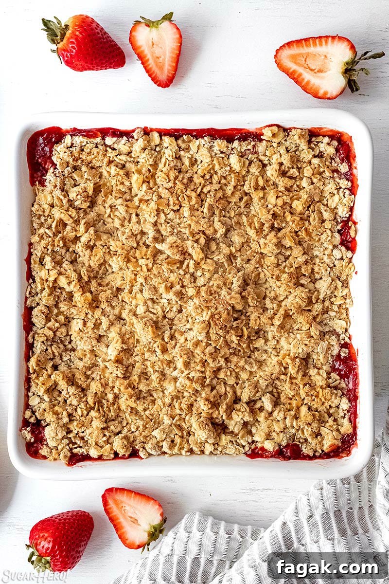Overhead shot of Strawberry Crisp baked in a square white pan.