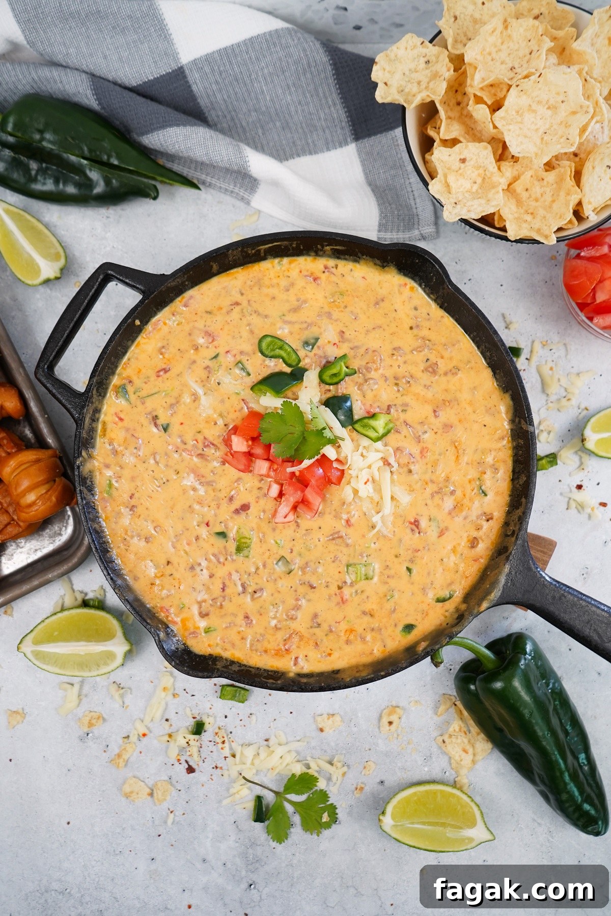 Smoked queso with pepper jack cheese and poblano peppers and chips in a bowl. Smoked queso with pepper jack cheese and poblano peppers and chips in a bowl.