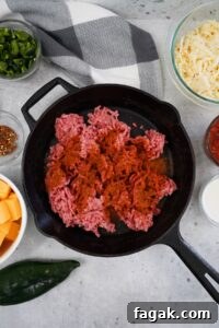 Smoked Poblano and Pepper Jack Queso Recipe 4 In a cast iron skillet break up the ground beef and season with the Spicy BBQ Rub