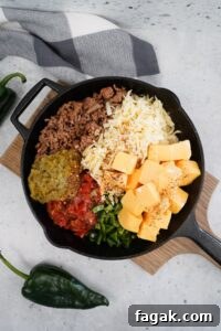 Smoked Poblano and Pepper Jack Queso Recipe 7 Push the seasoned meat to the side of the pan and add in the Velveeta pepper jack cheese diced tomatoes with liquid green chiles poblano peppers red pepper flakes and milk. Do not stir