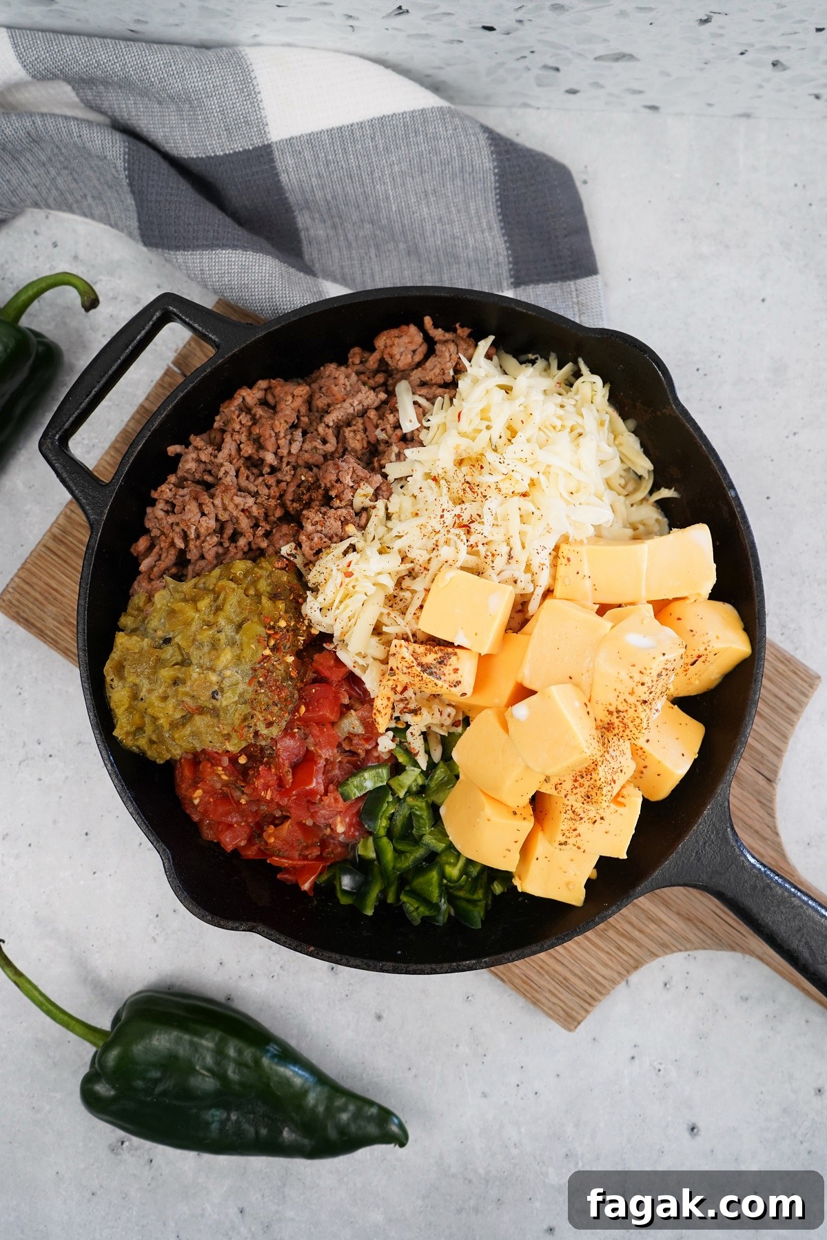 Queso ingredients in cast iron pan before going in the smoker. Queso ingredients in cast iron pan before going in the smoker.