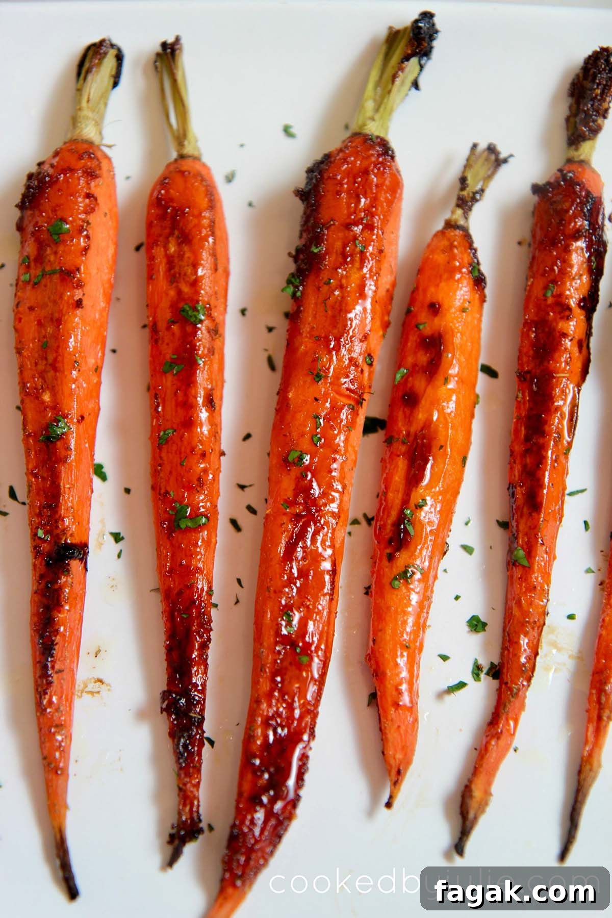 honey garlic carrots on a white platter.