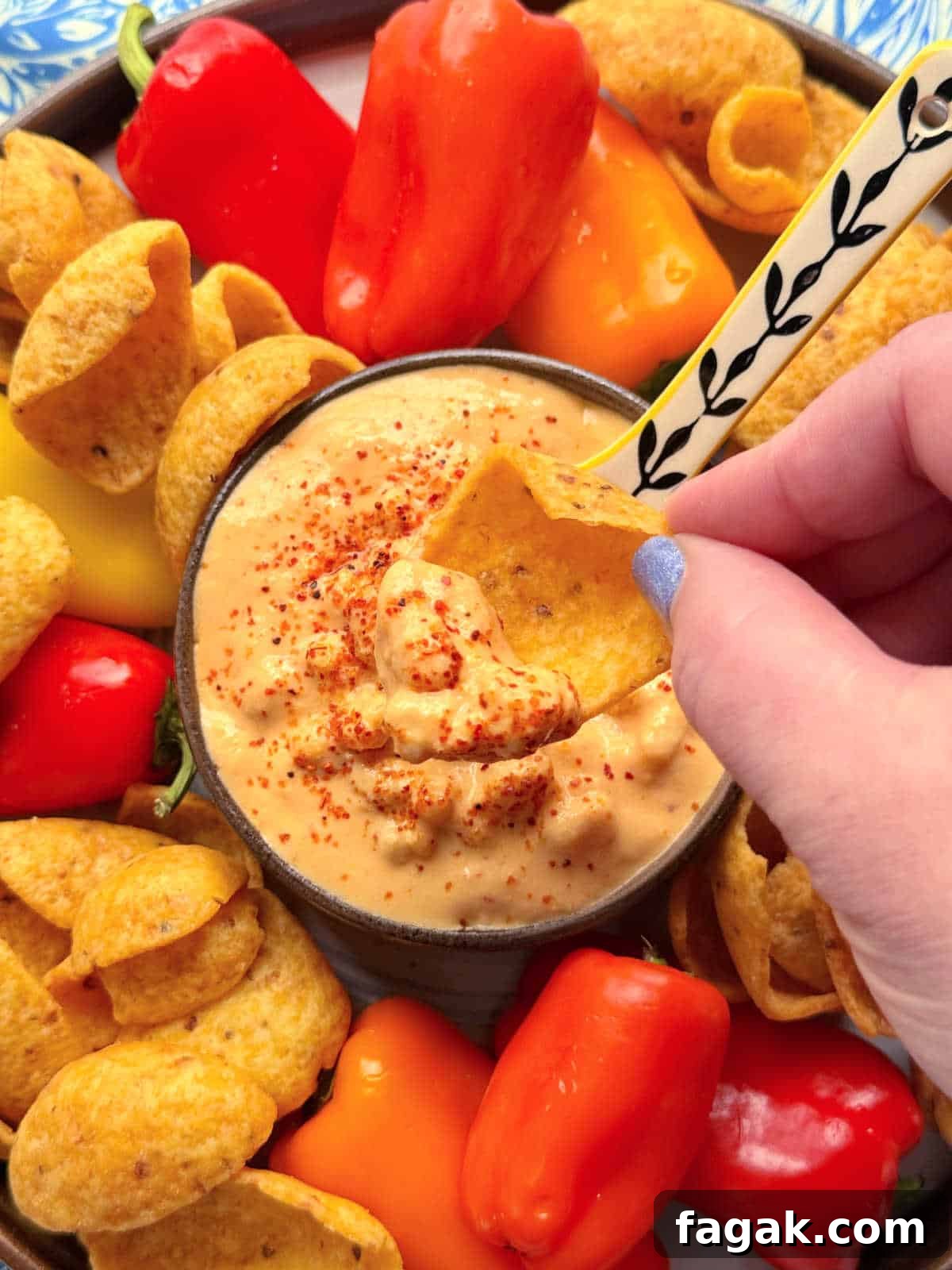 dipping a Frito scoop into the corn dip