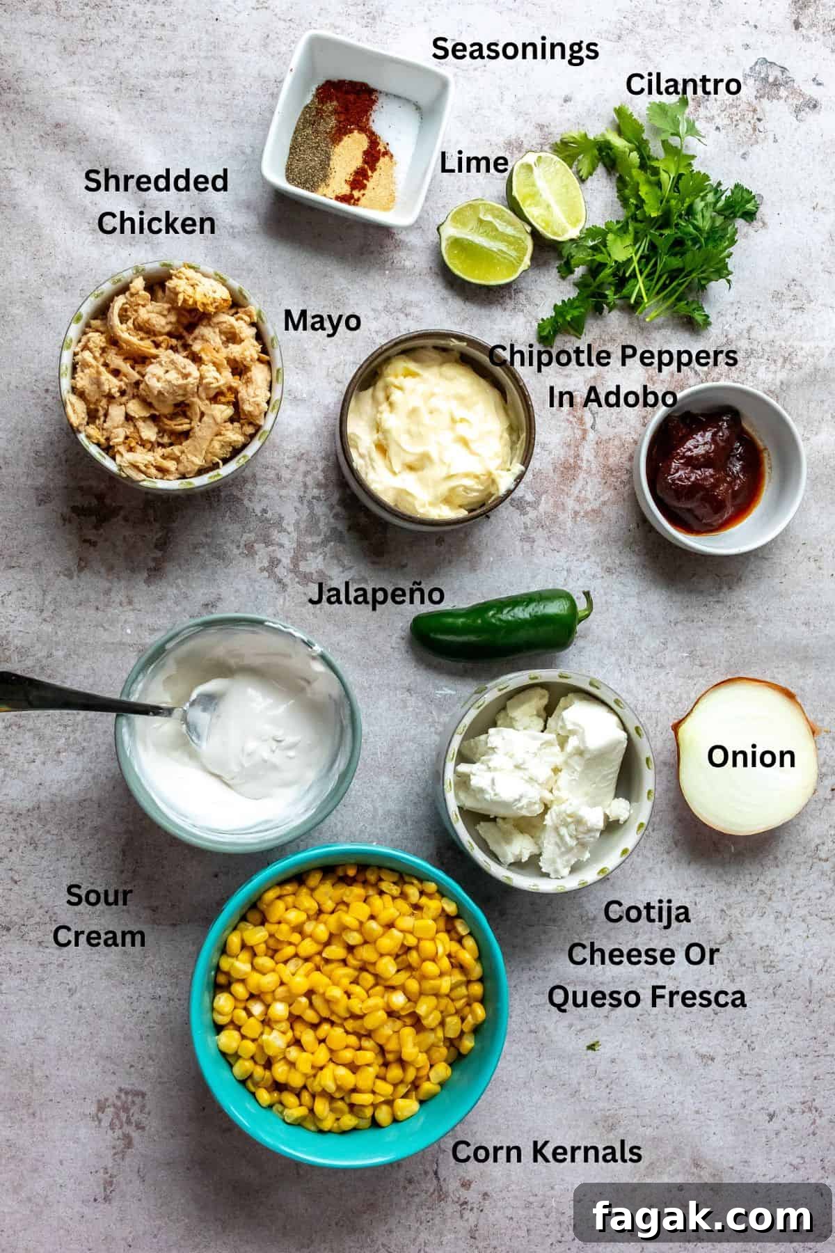 An overhead image of the ingredients of Mexican street corn casserole in separate containers with labels.