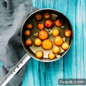 Gulab Jamun in syrup on the stove.