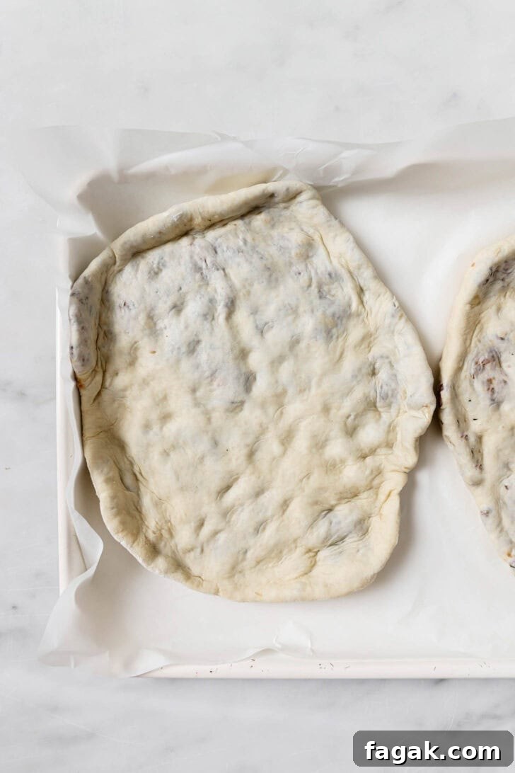 Foolproof Keema Naan Recipe: Step-by-Step Guide for Perfect Stuffed Bread 13 Keema Naan on a baking sheet about to be baked.
