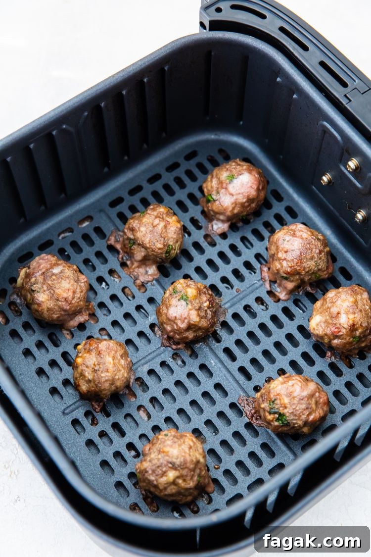 cooked keto meatballs in an air fryer basket