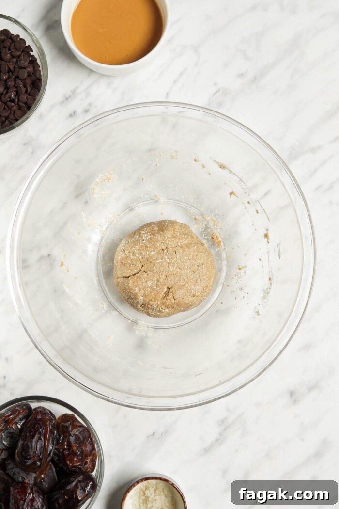 Ball of dough in a large glass mixing bowl.