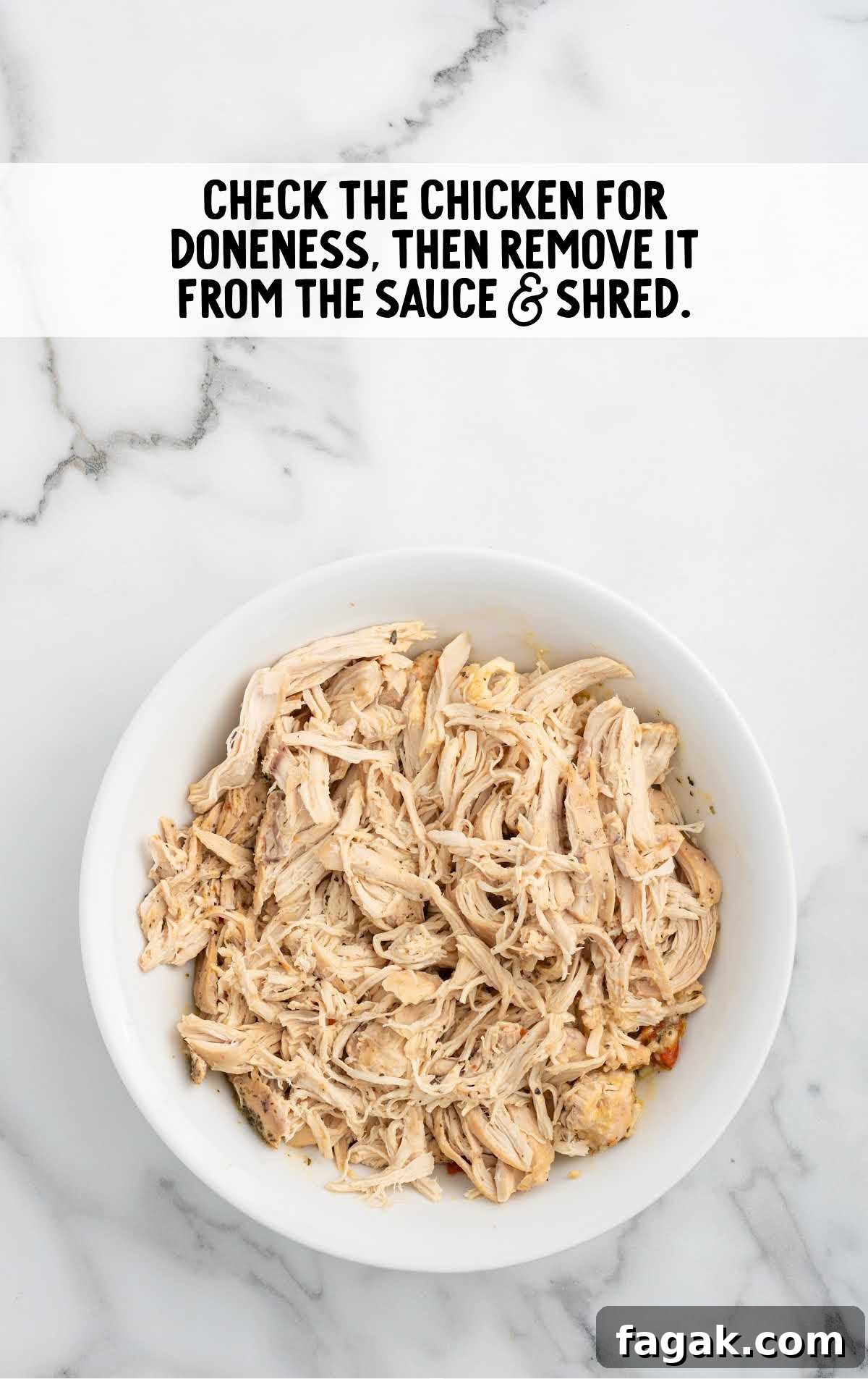 cooked chicken shredded in a bowl