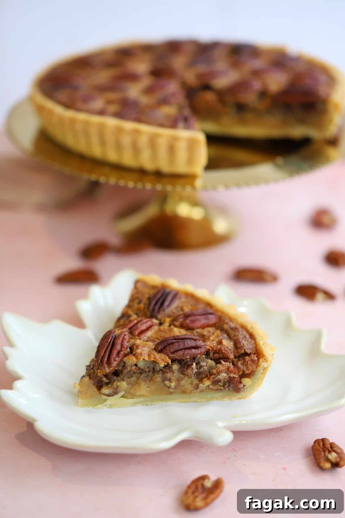 A slice of gluten free pecan pie with pecan pie behind it on a plate.