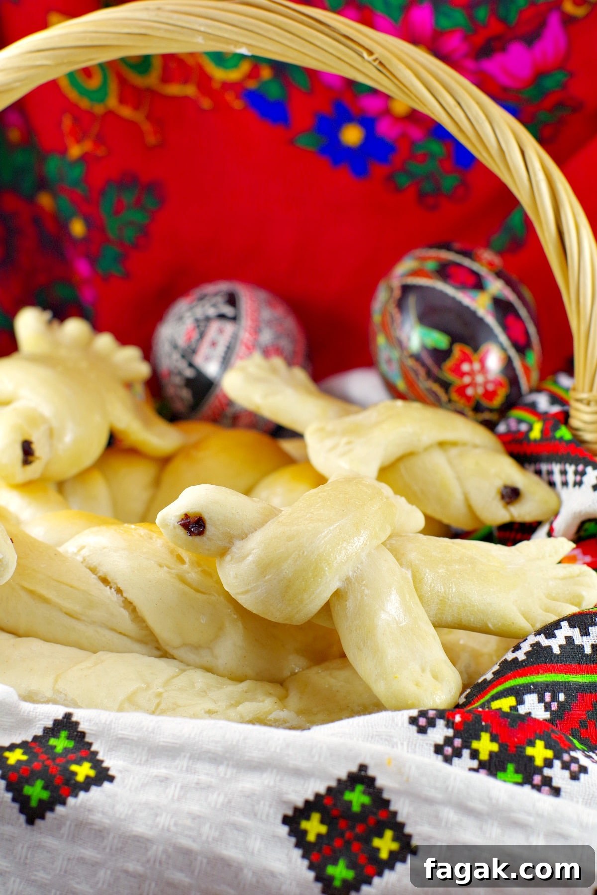 Ukrainian Easter bread doves in basket with Ukrainian Easter Eggs in background