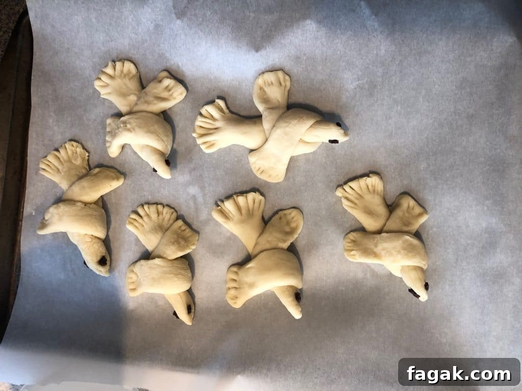 bread doves on parchment lined baking sheet