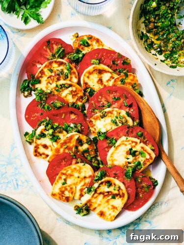 Seared Halloumi and Tomato Salad with herb gremolata on a serving plate.