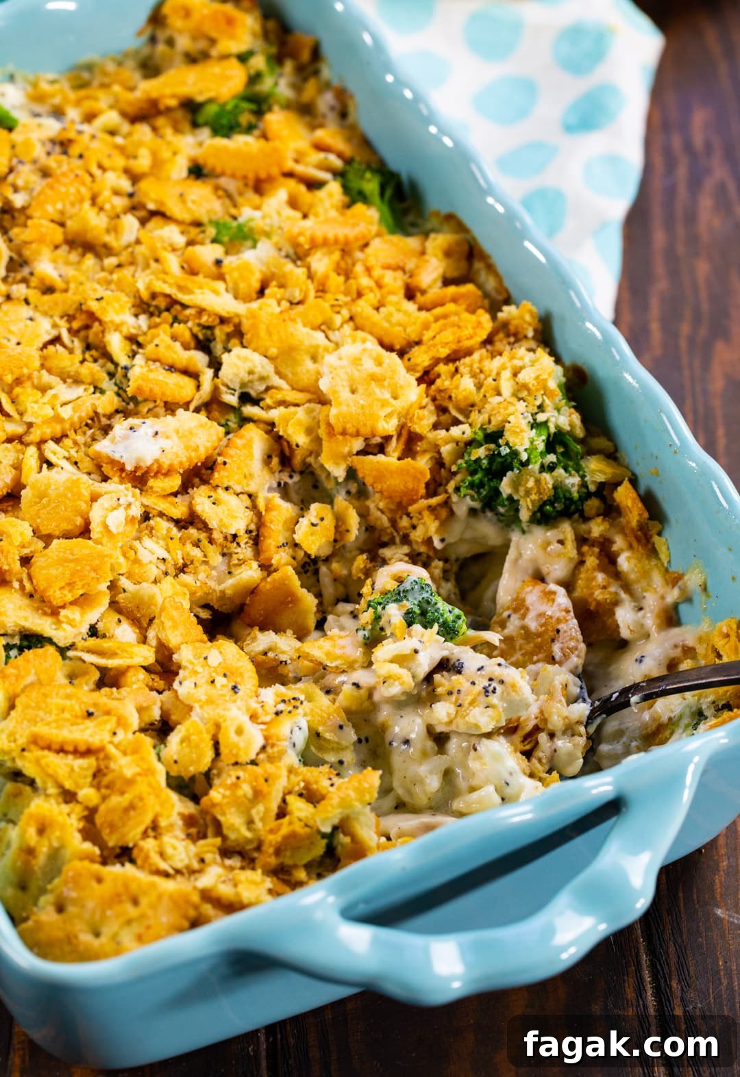 Poppy Seed Casserole in baking dish with spoon.