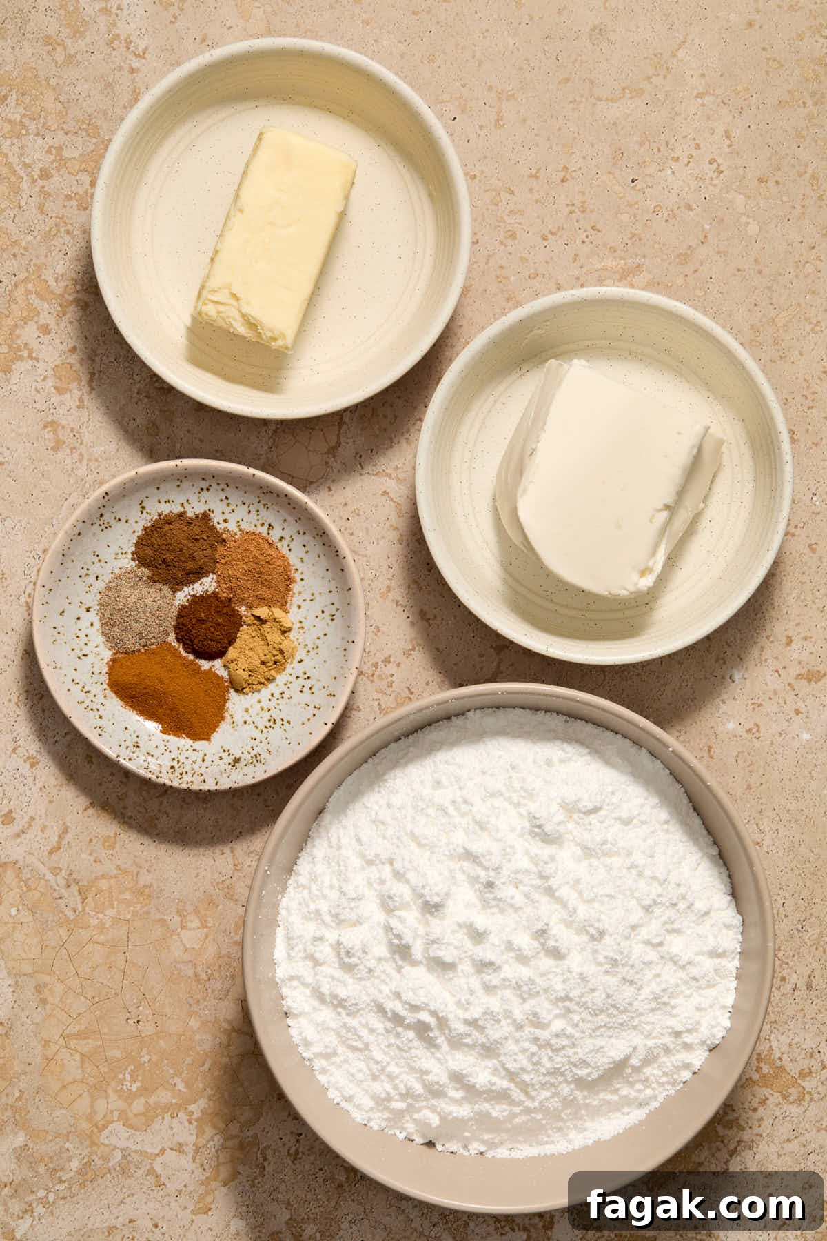 Ingredients to make the spiced cream cheese frosting arranged individually.