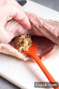 spreading stuffing into a pocket in a pork roast