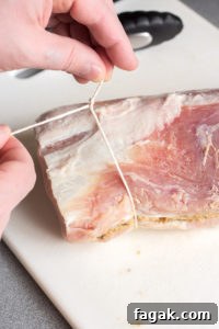 tying kitchen twine on a pork roast