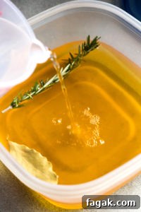 pouring water into a container with apple juice