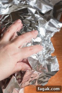 putting foil over a smoked pork loin roast