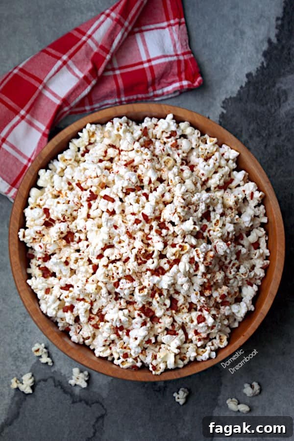 Overhead photo of a large wooden bowl of popcorn.