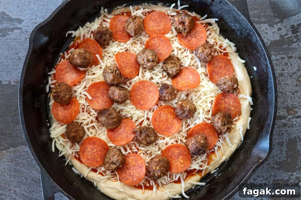 pizza dough in skillet with toppings.