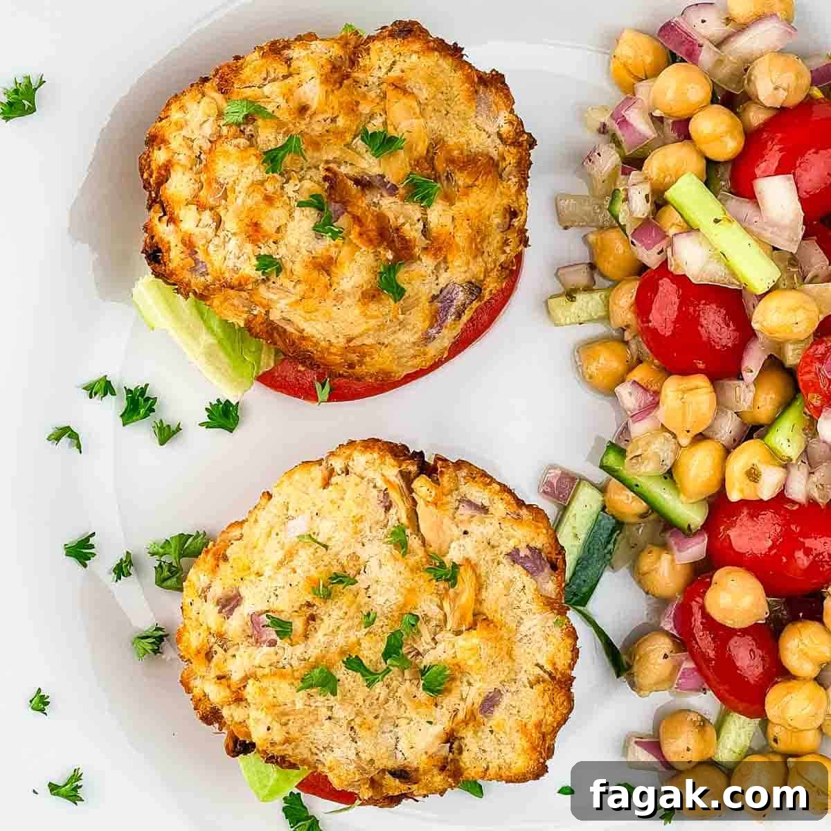 Easy to make Air Fryer tuna patties served with lettuce, tomato, and chickpea salad, garnished with parsley.