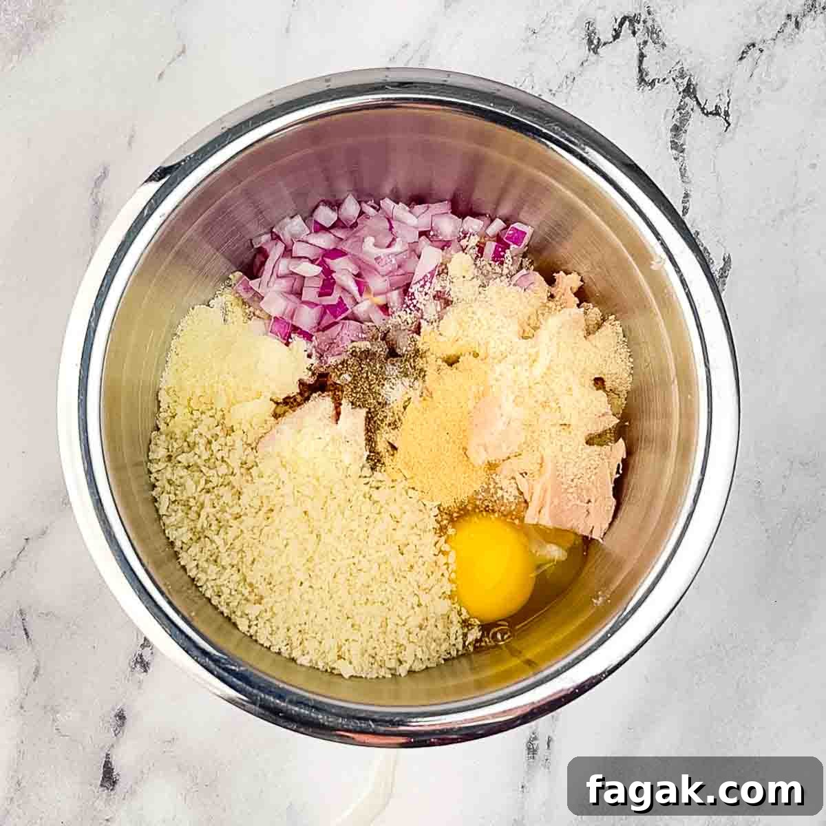 The ingredients for the tuna patties in a medium mixing bowl.
