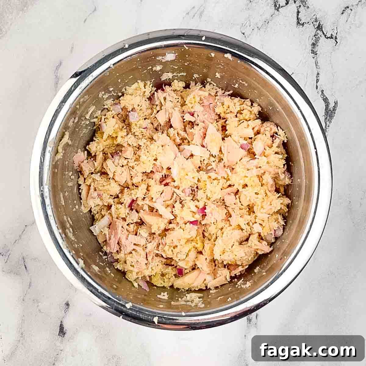 The ingredients for the tuna cakes combined in a medium mixing bowl.