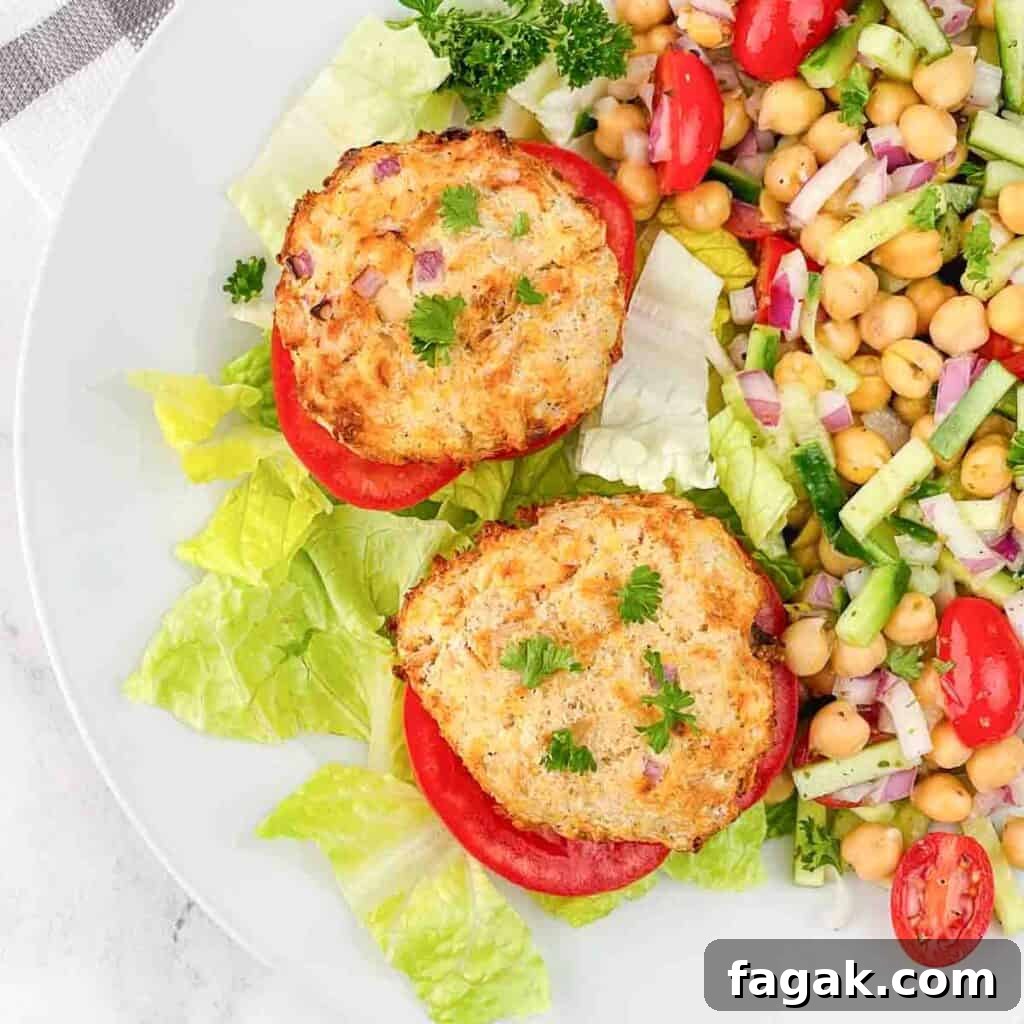Crispy tuna patties on a tomato with chickpea salad on the side.