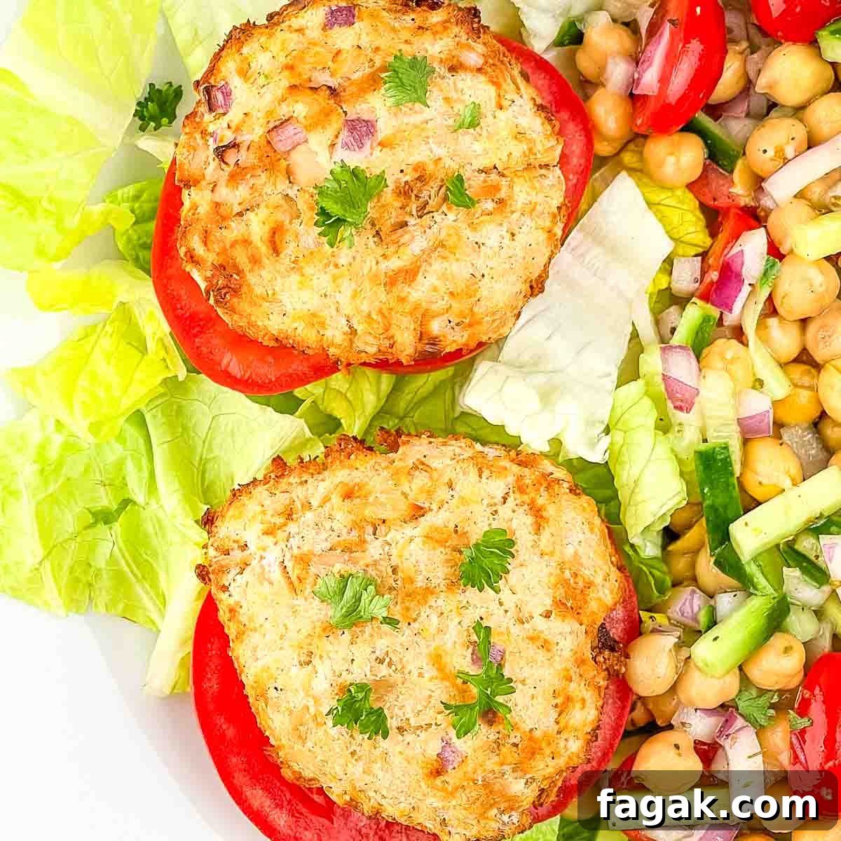 Air fried tuna cakes on a slice of tomato, garnished with fresh parsley.