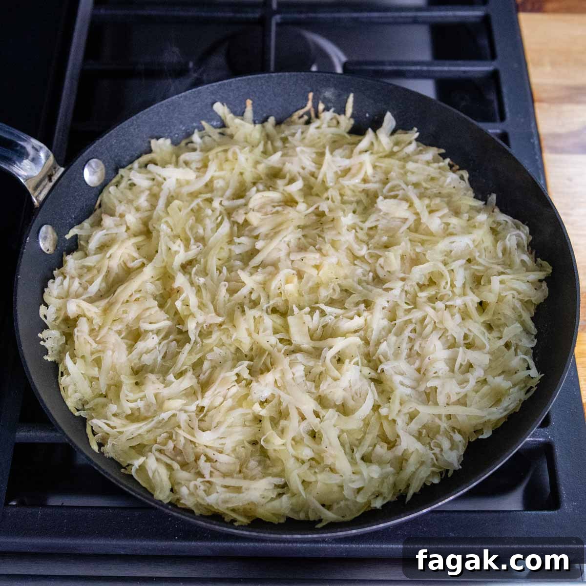 rosti being cooked in a skillet.