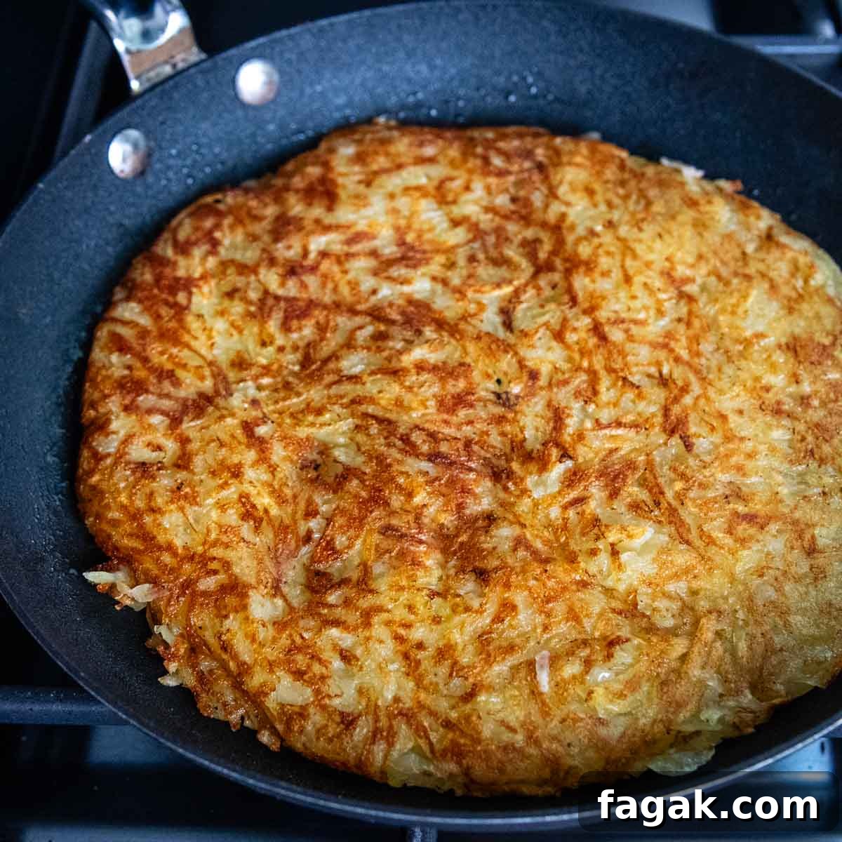 overhead shot of potato rosti in a skillet.