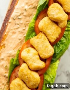 close up overhead shot of open chicken nugget sandwich showing filling