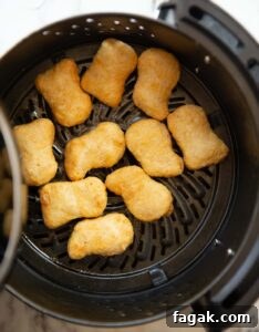overhead shot of cooked chicken nuggets in the air fryer