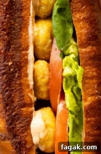 close up shot of chicken nugget sandwich showing filling