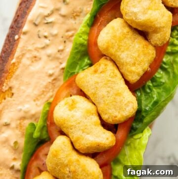 close up overhead shot of open chicken nugget sandwich showing filling